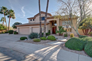 Front of 2 story house with 3 car garage