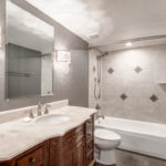 updated bathroom counter and tiled tub area