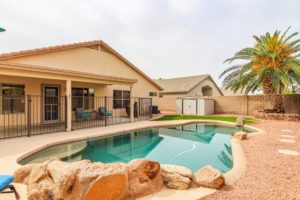 single level home with fenced back yard and pebble tec pool