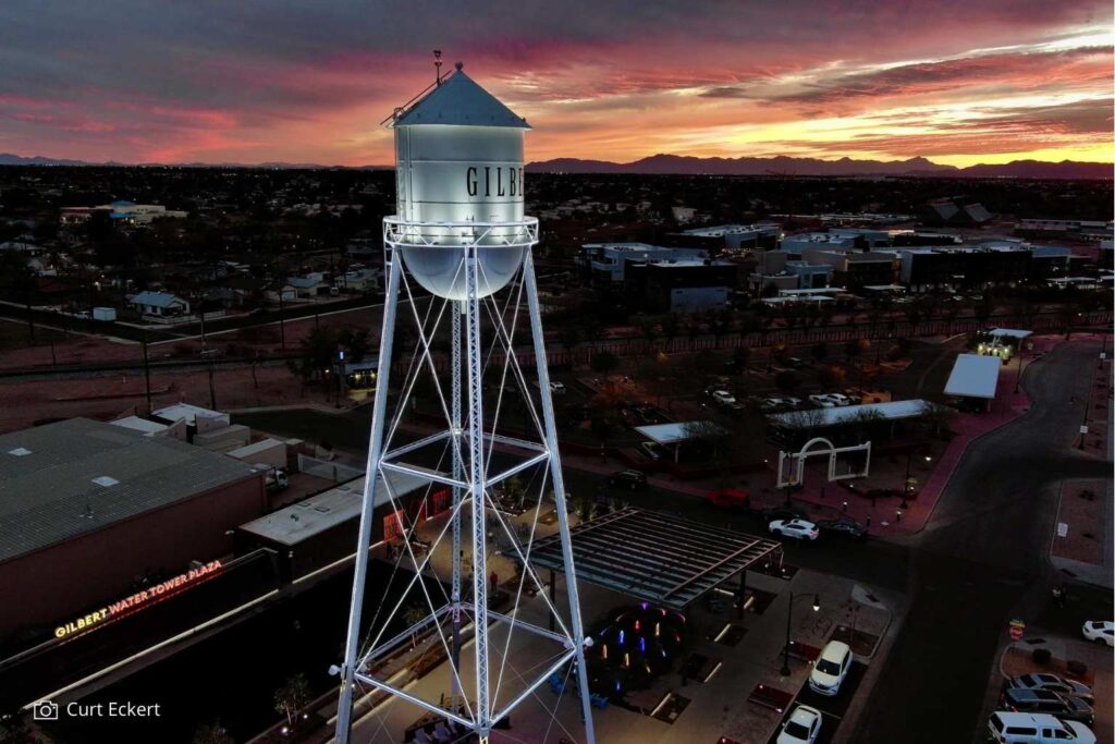 Downtown Gilbert water tower at sunset with lights