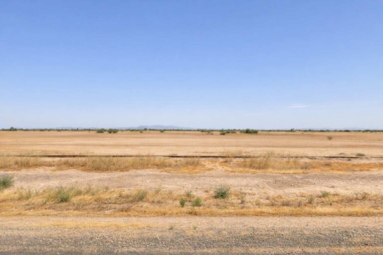 Open desert land in Eloy, Arizona with distant mountains