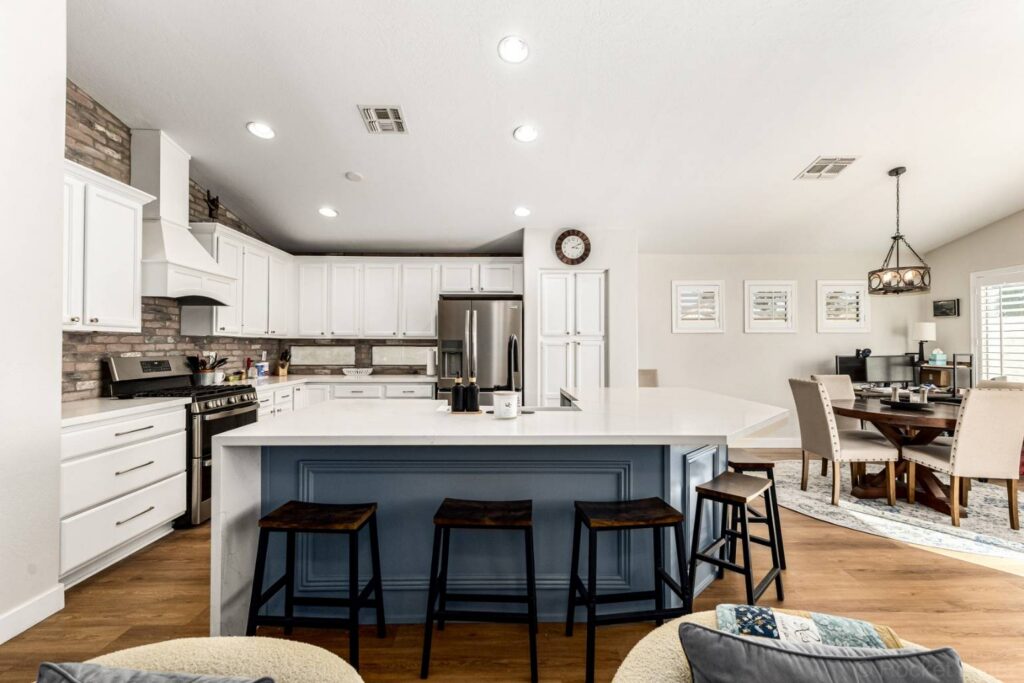 Updated kitchen featuring quartz waterfall island and custom tile backsplash at 275 W Oriole Way Chandler AZ