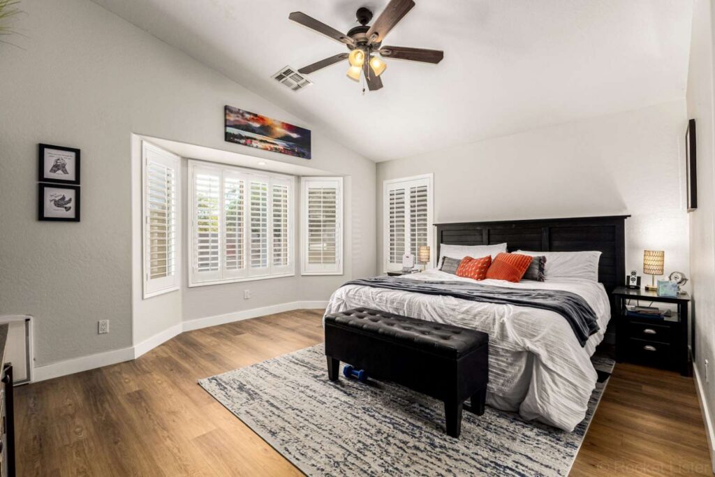 Spacious primary bedroom suite with updated luxury vinyl plank flooring and neutral tones at 275 W Oriole Way Chandler AZ