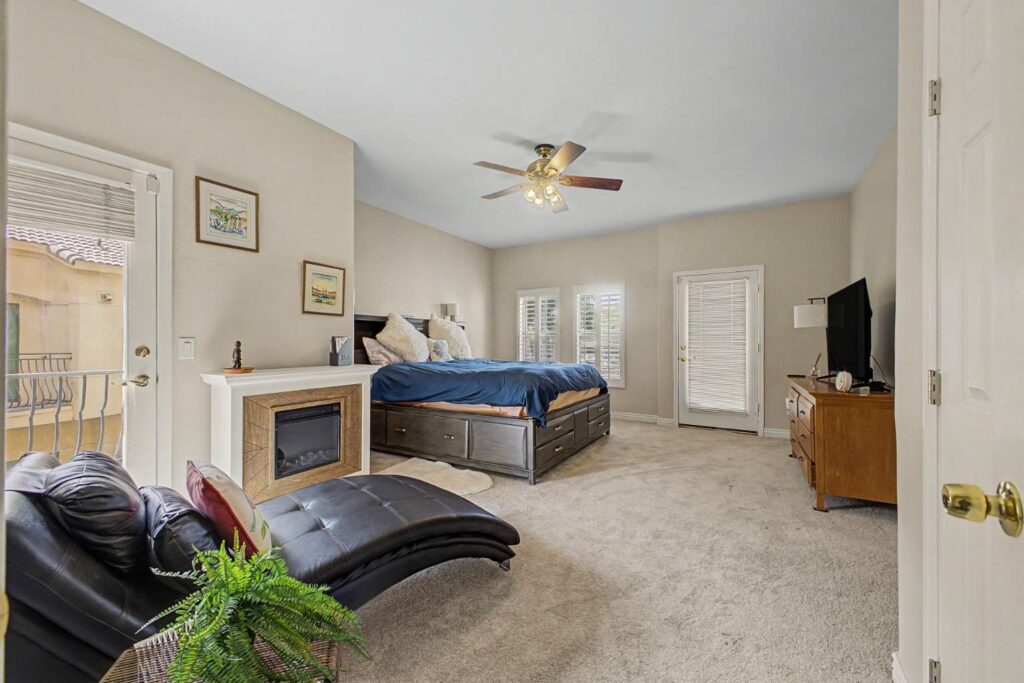 spacious primary bedroom with balcony access and natural light