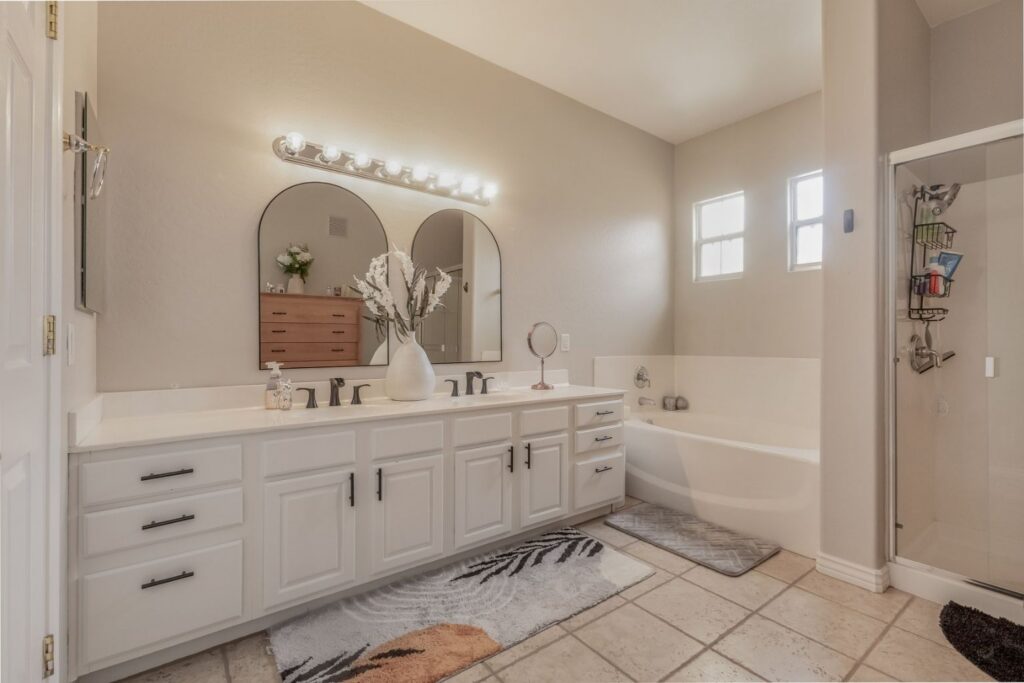 Primary suite bathroom with double sinks and walk-in shower in Ahwatukee townhome
