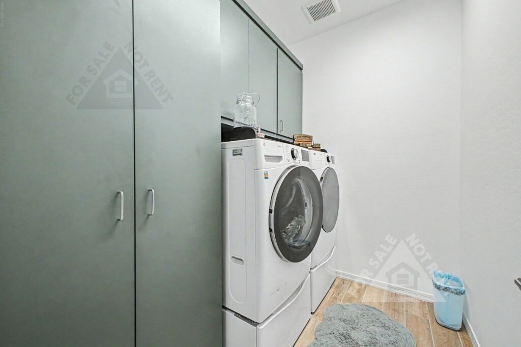 Custom laundry-room cabinetry in a highly upgraded CantaMia home