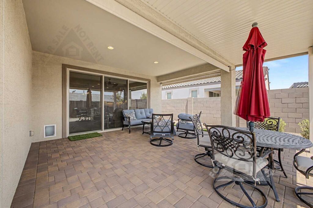 Extended covered patio with solar-powered electric shades at a CantaMia home