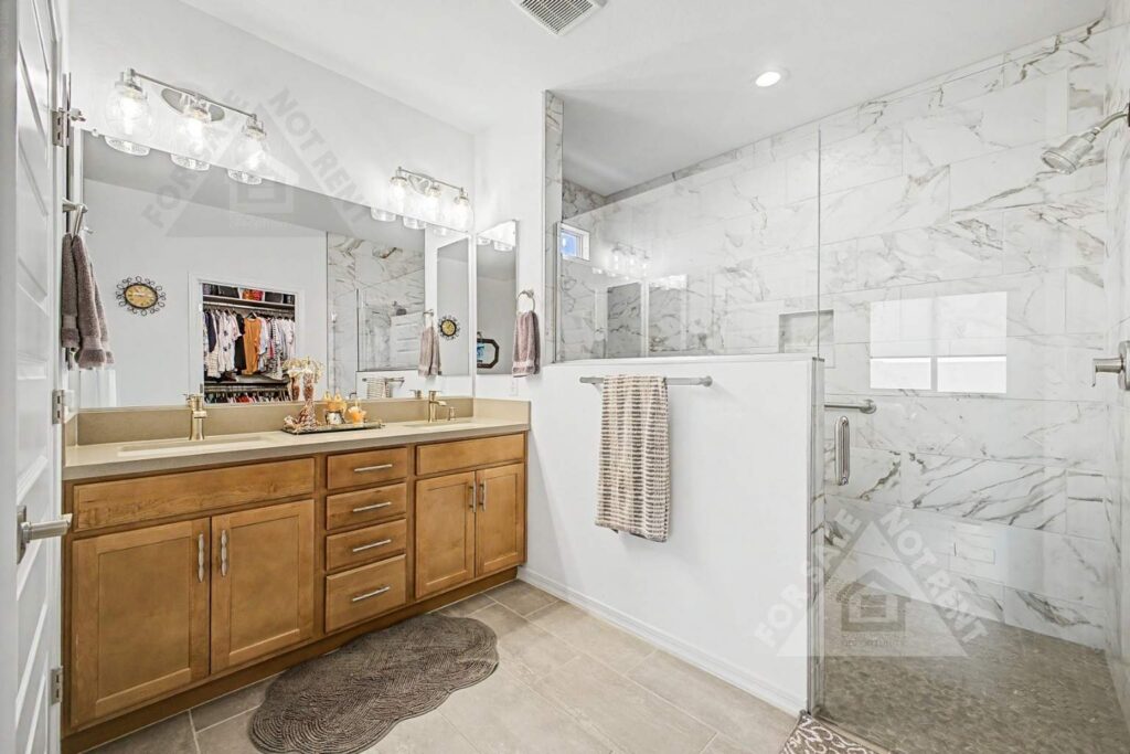 Primary bathroom with oversized walk-in shower in a 2025 CantaMia home